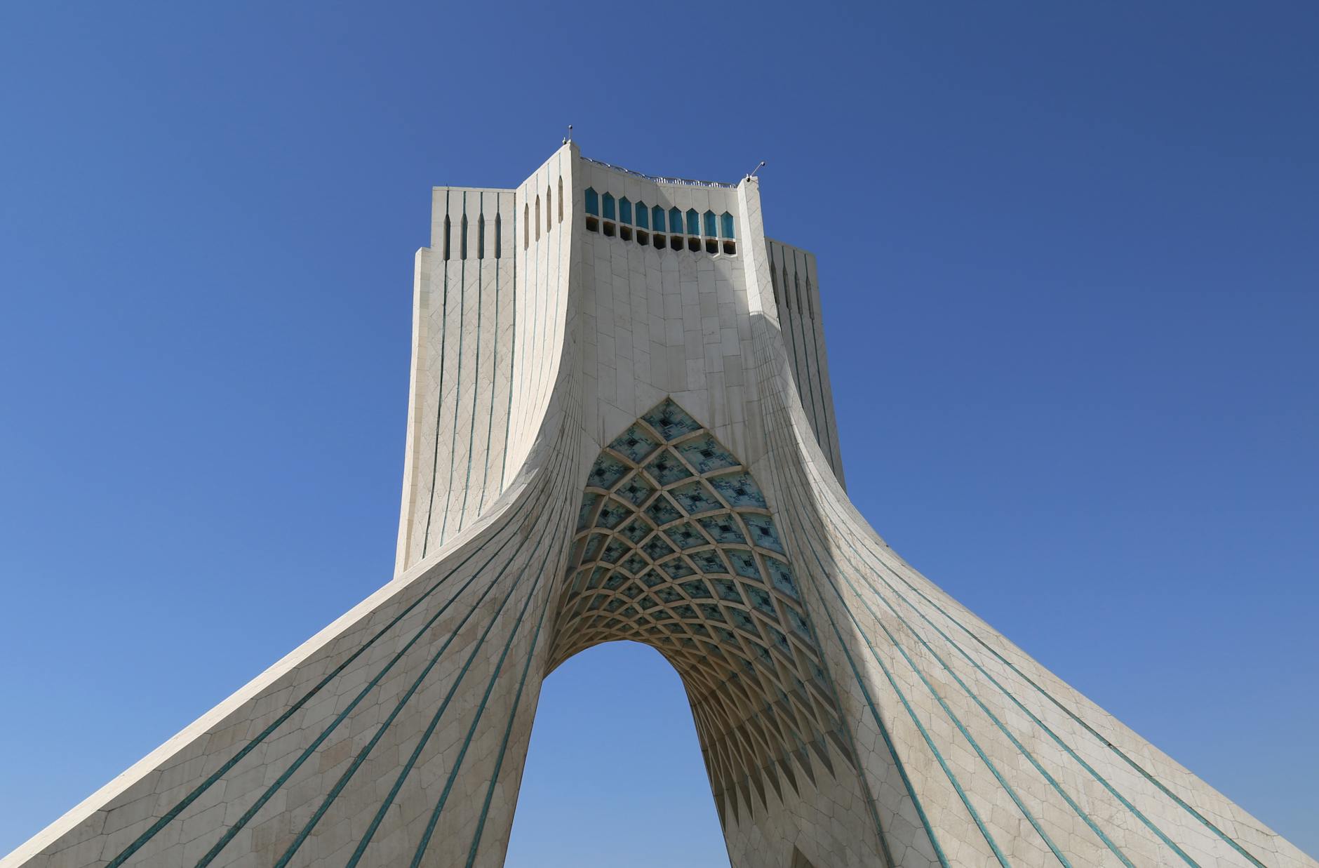 Azadi Tower in Tehran, Iran, under a clear blue sky, showcasing modern architectural beauty.