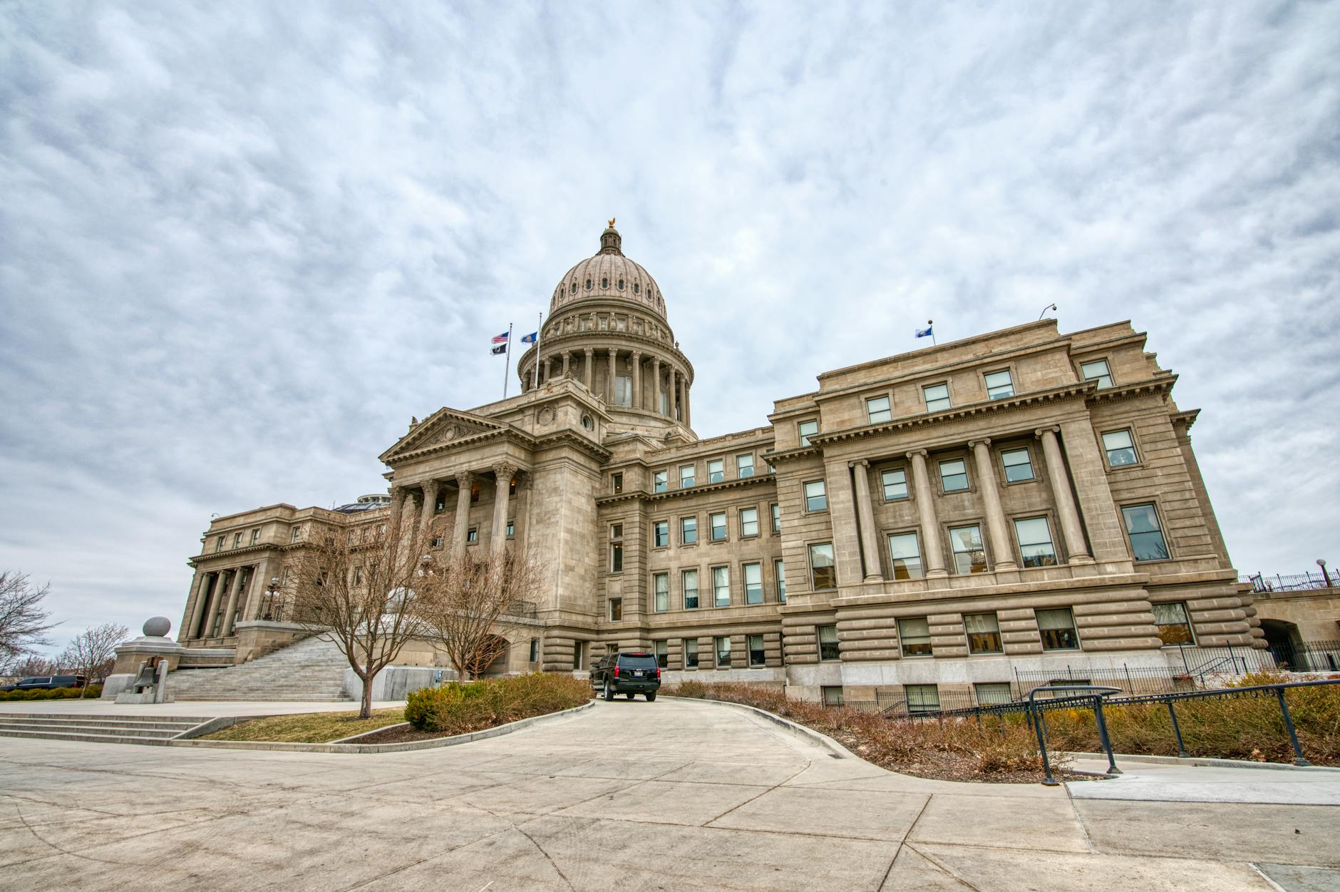Majestic view of the Idaho State Capitol with its iconic dome under a cloudy sky.