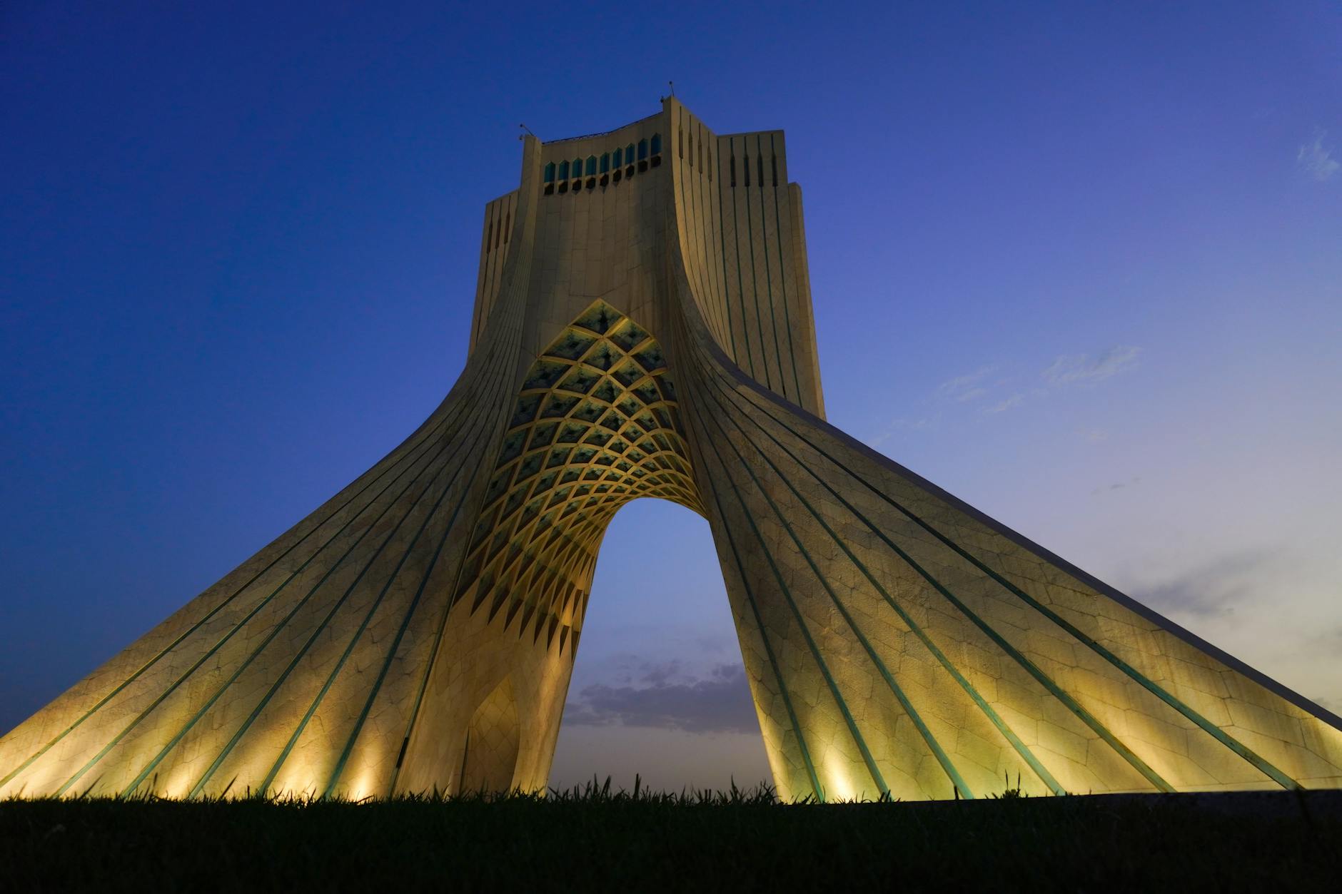 A captivating view of the Azadi Tower in Tehran against a blue twilight sky.