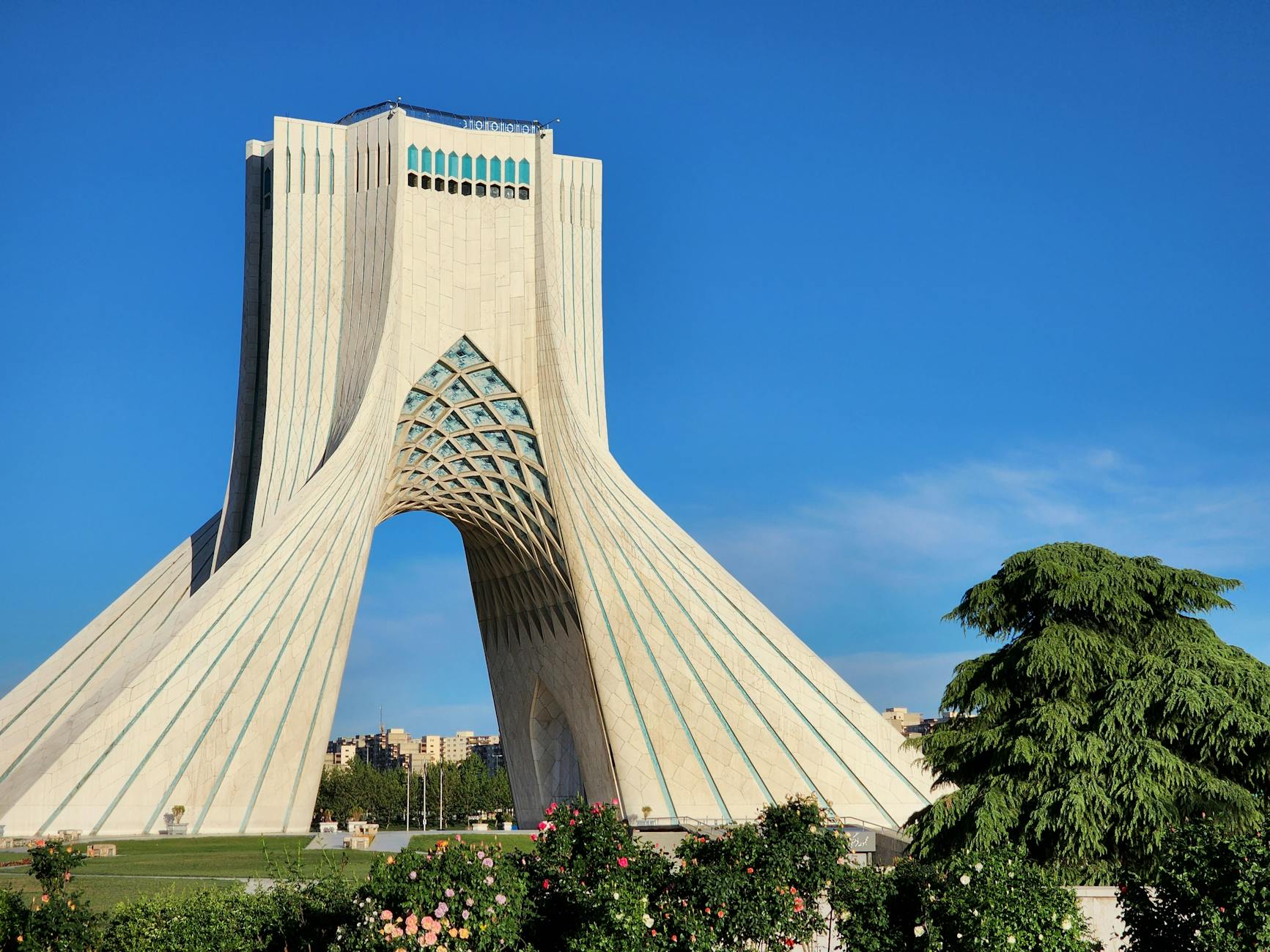 Azadi Tower, a prominent architectural landmark in Tehran, Iran, captured on a sunny day.