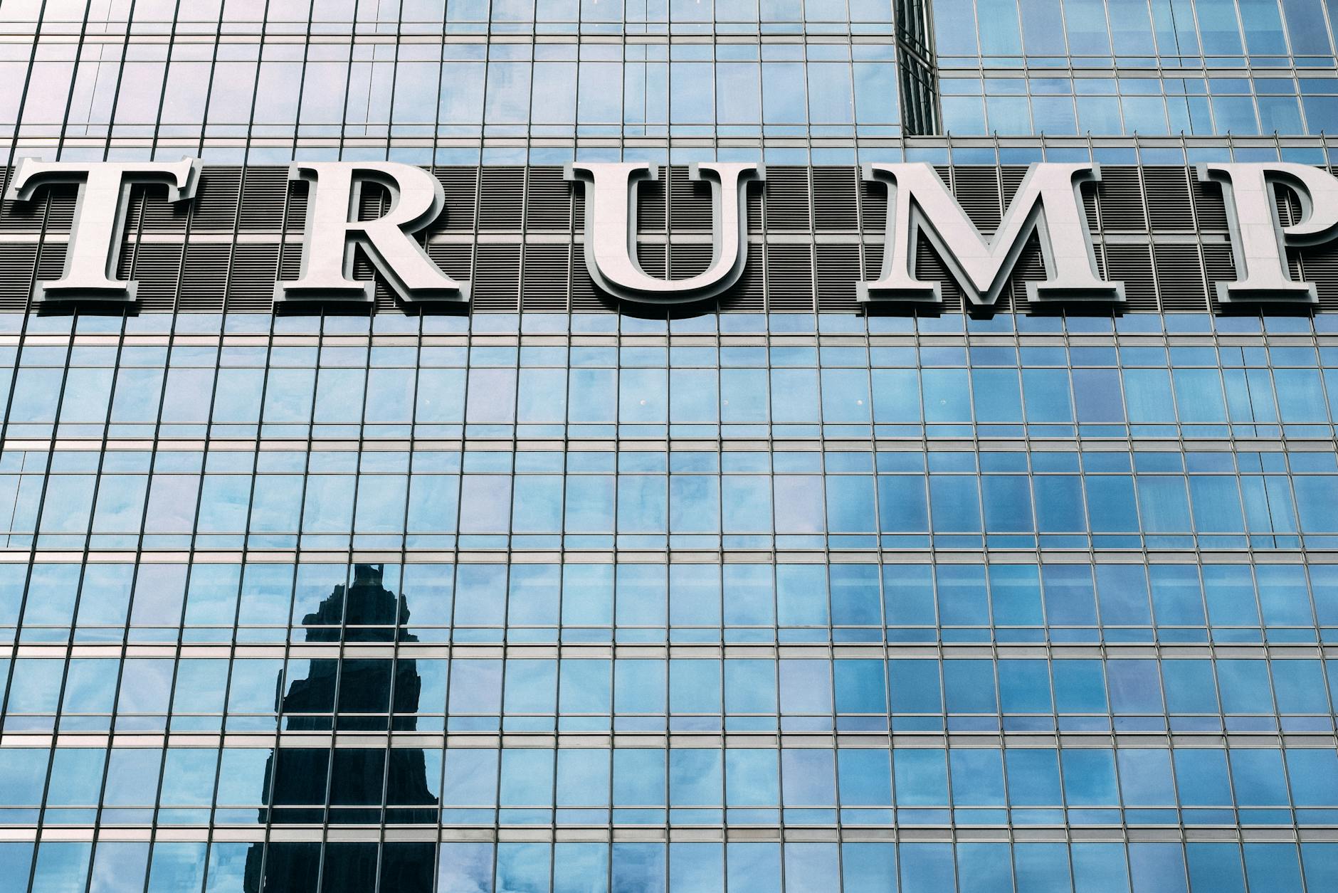 Close-up of Trump Tower's glass facade with the city skyline reflection in the windows.