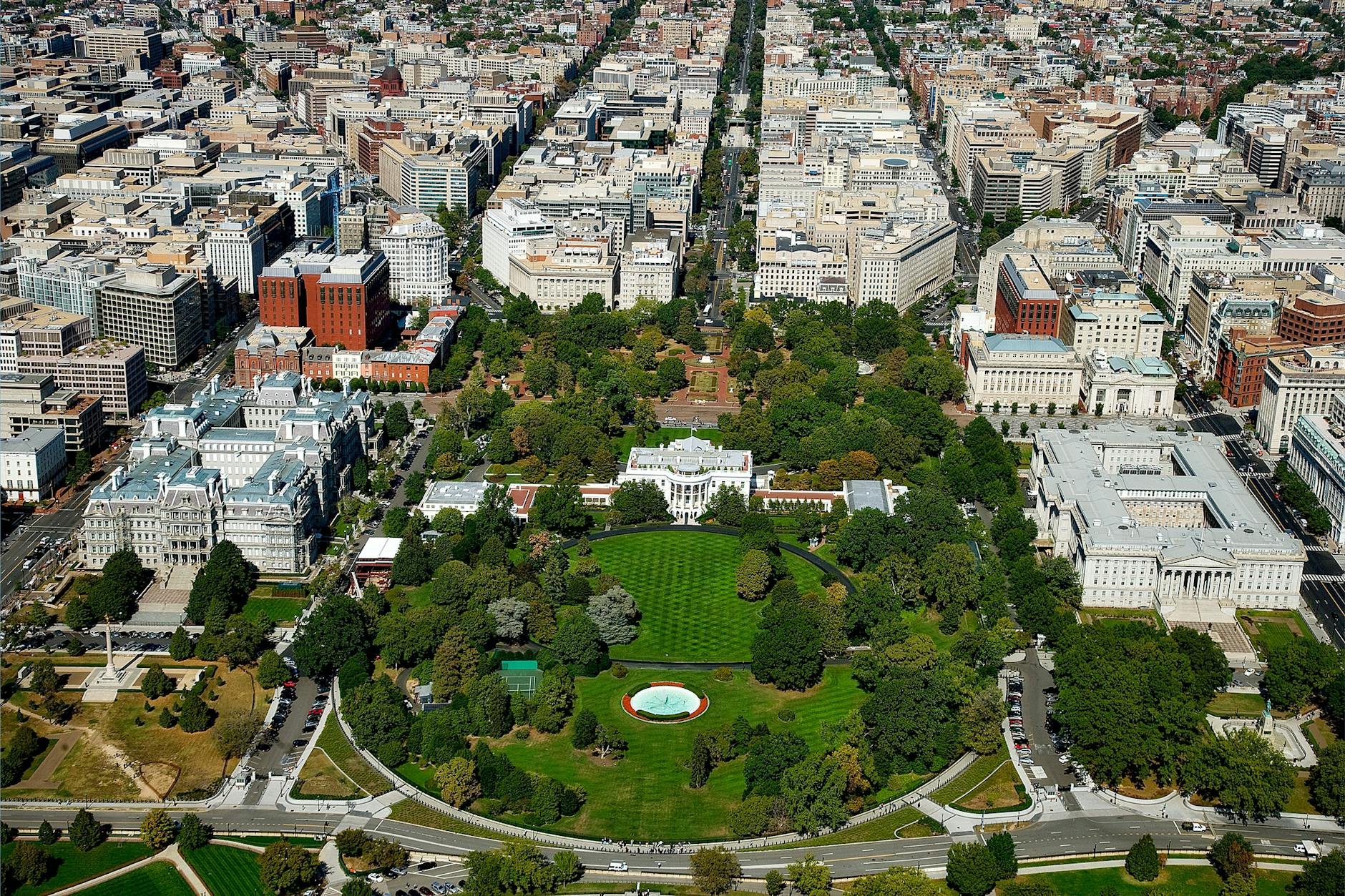 A stunning aerial view of The White House surrounded by downtown Washington D.C.'s architecture and green spaces.