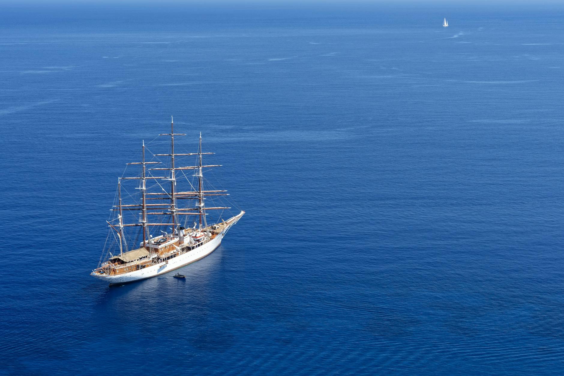 Aerial view of a classic sailing ship in the deep blue Aegean Sea near Greece.