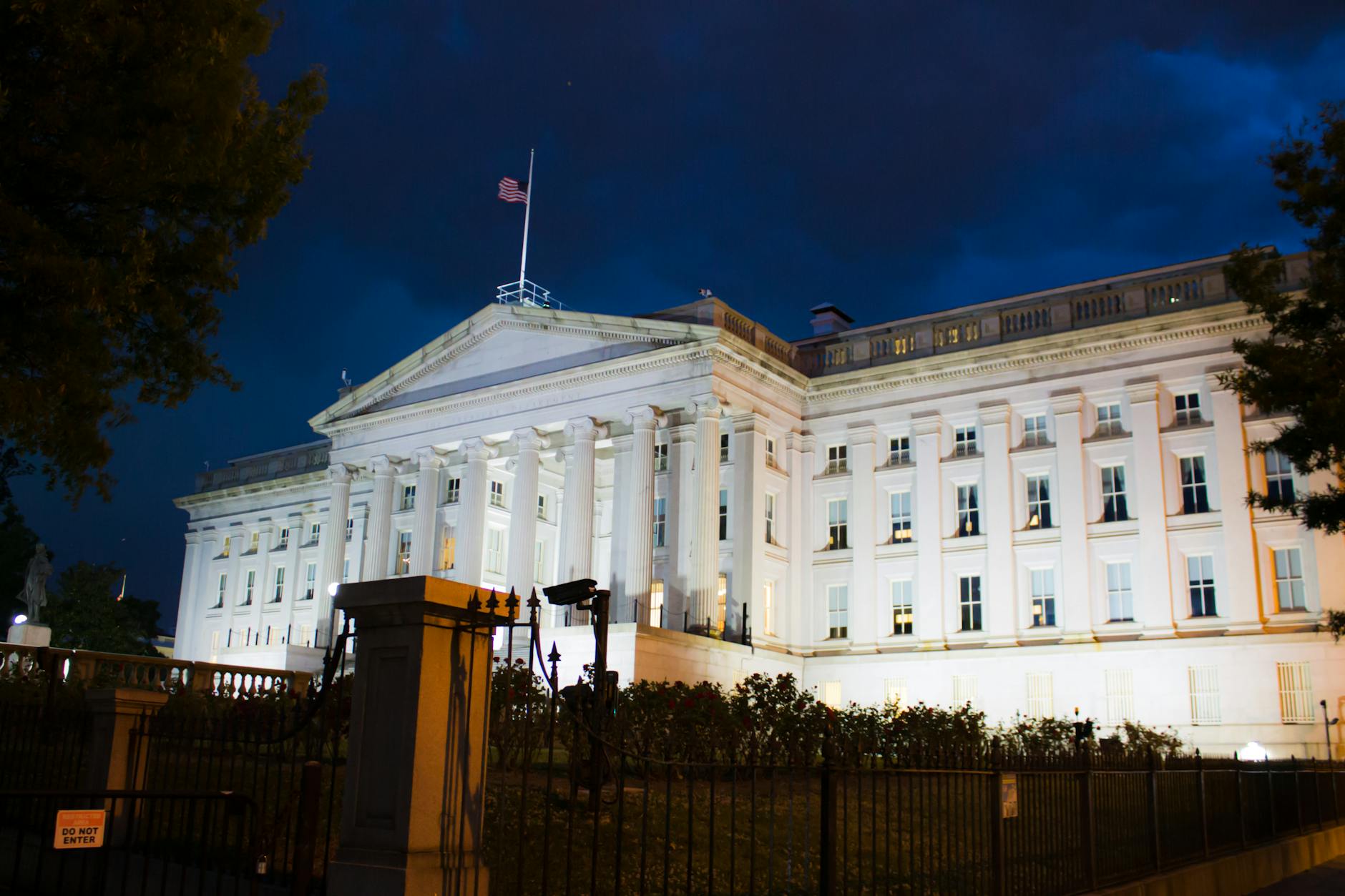 Stunning view of the U.S. Treasury Building illuminated against a twilight sky in Washington, DC.
