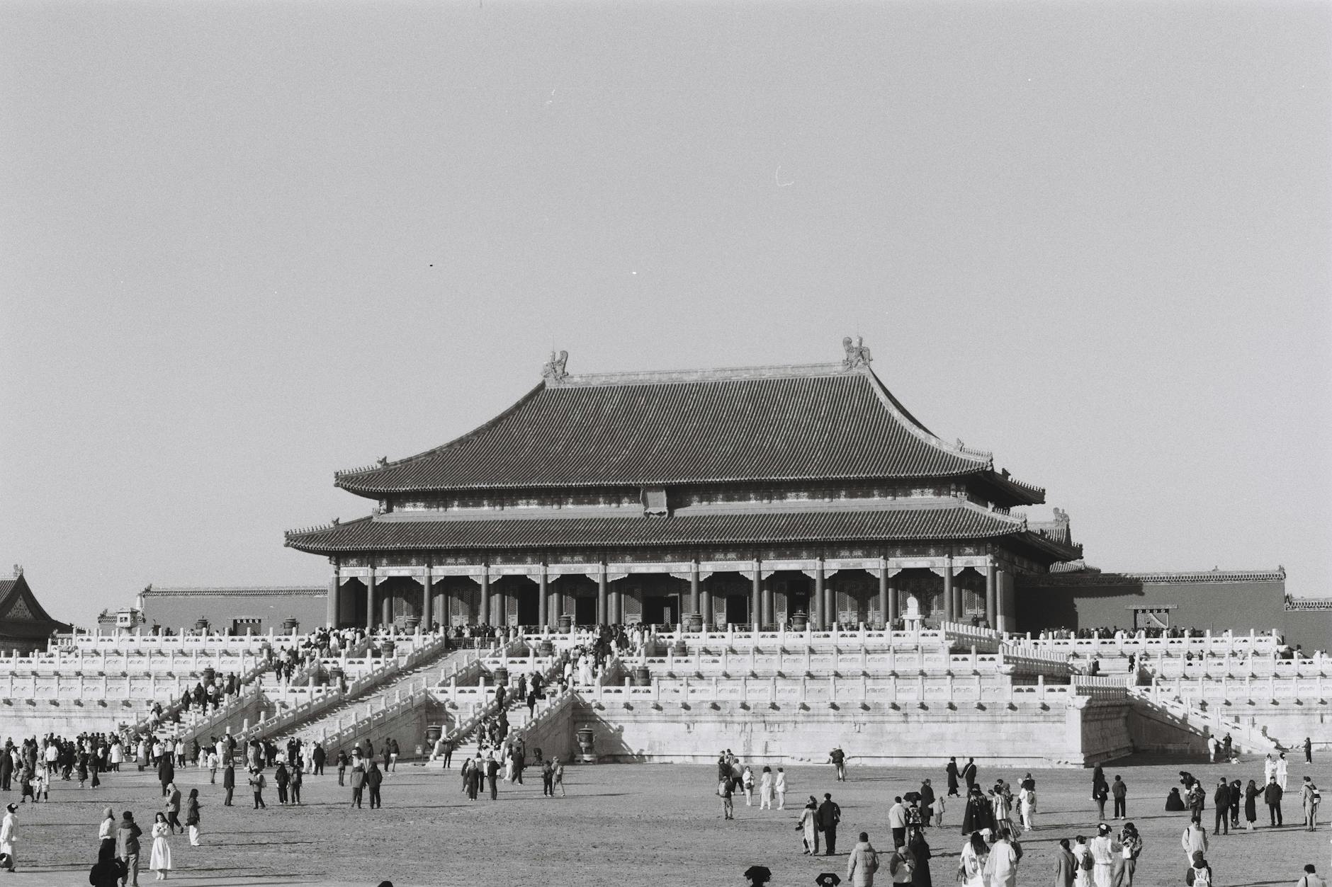 Black and white image of the Forbidden City with visitors exploring the iconic landmark.