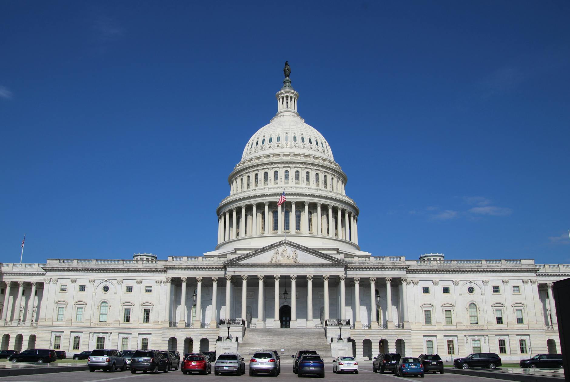 A striking image of the United States Capitol Building under a clear blue sky, symbolizing American democracy.