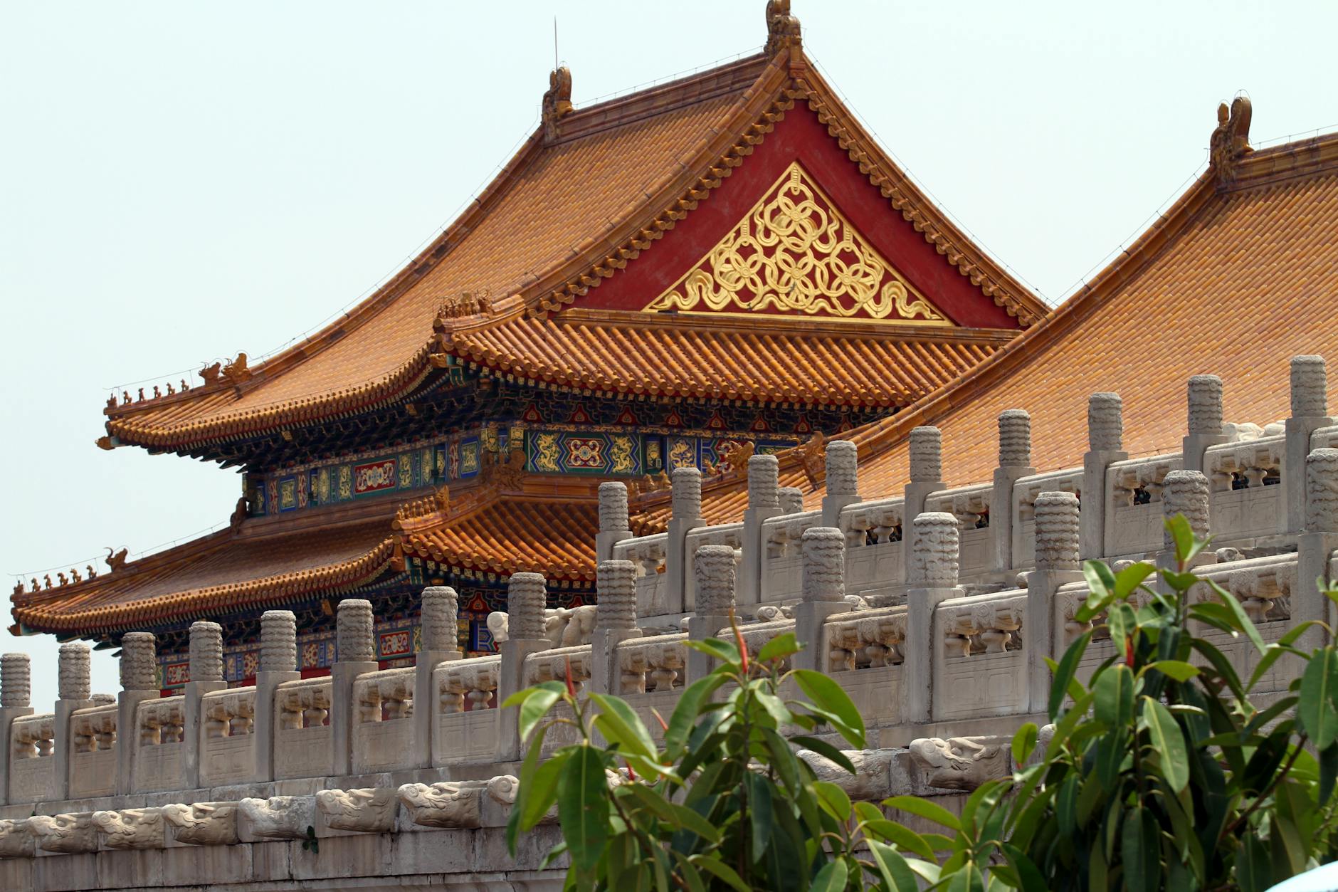 Ornate architecture of the Forbidden City in Beijing, China captured under a bright sky.