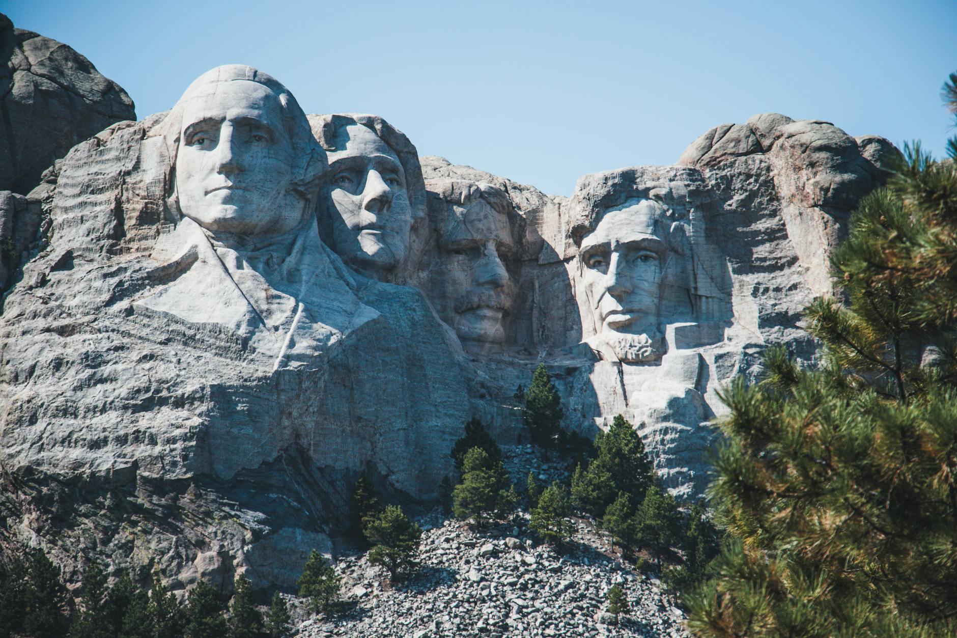 Iconic view of Mount Rushmore with presidential sculptures on a sunny day.