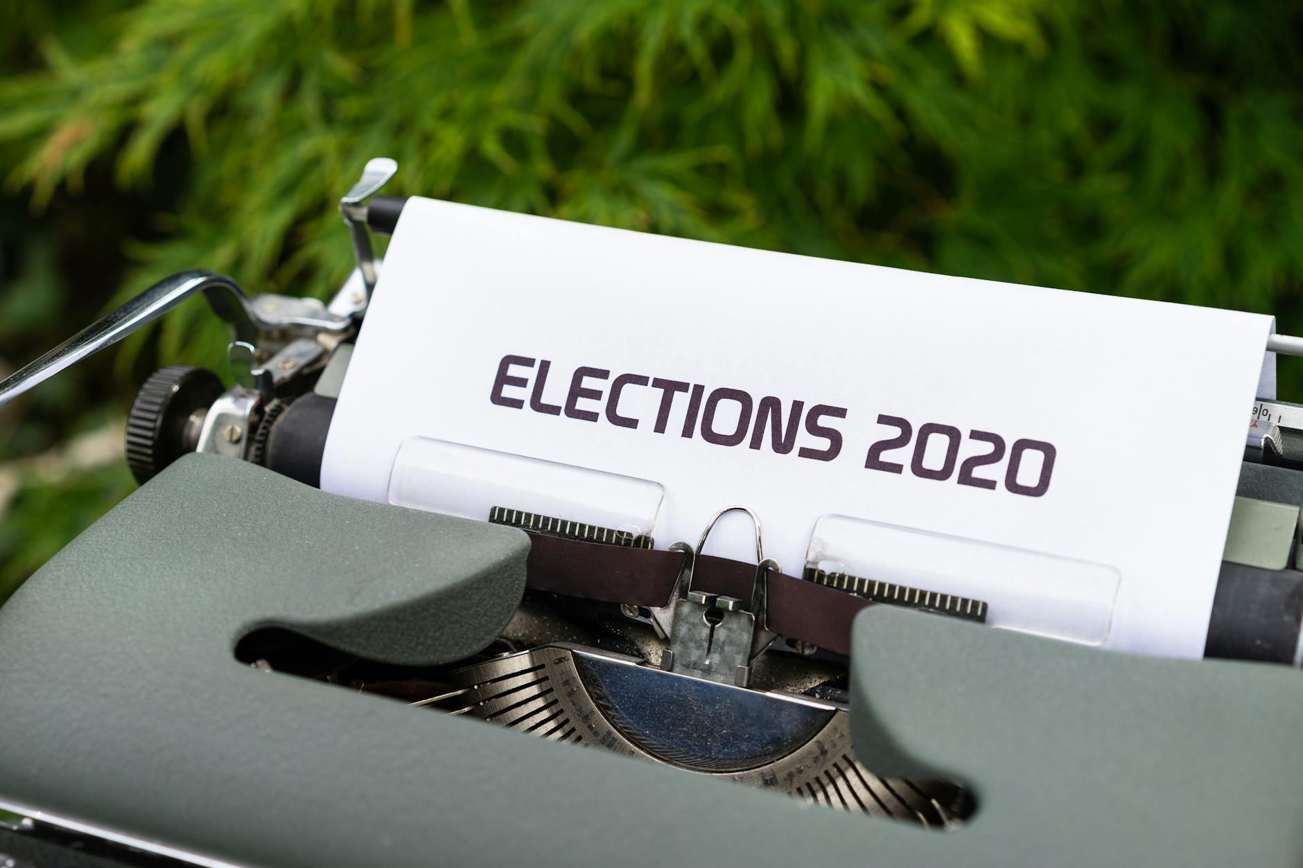 Close-up of a typewriter typing 'Elections 2020' outdoors.