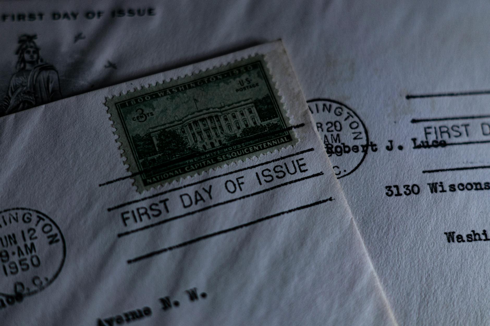 A close-up of a vintage first day of issue postage stamp on an envelope, evoking nostalgia.