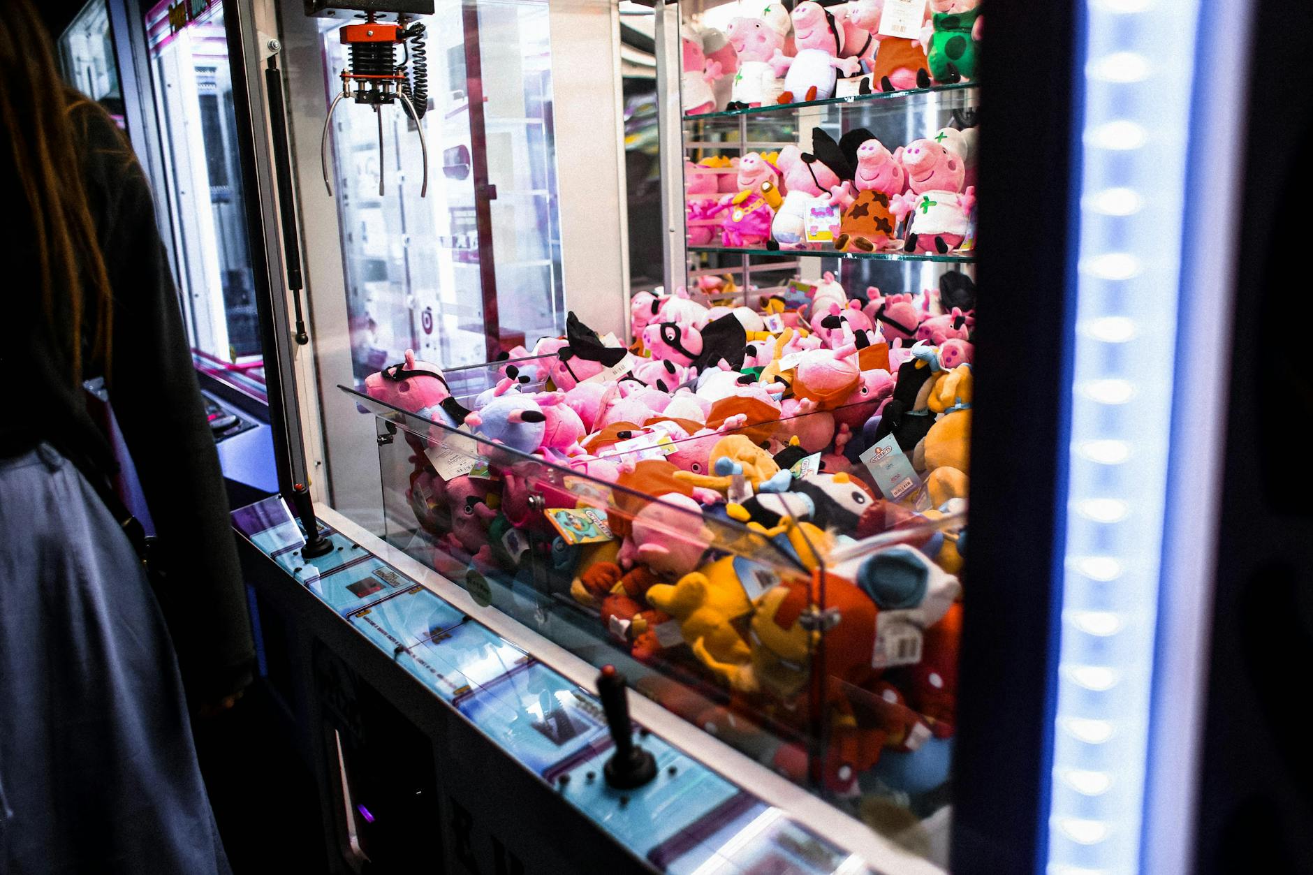 Bright arcade claw machine filled with cute plush toys, perfect for games and entertainment themes.
