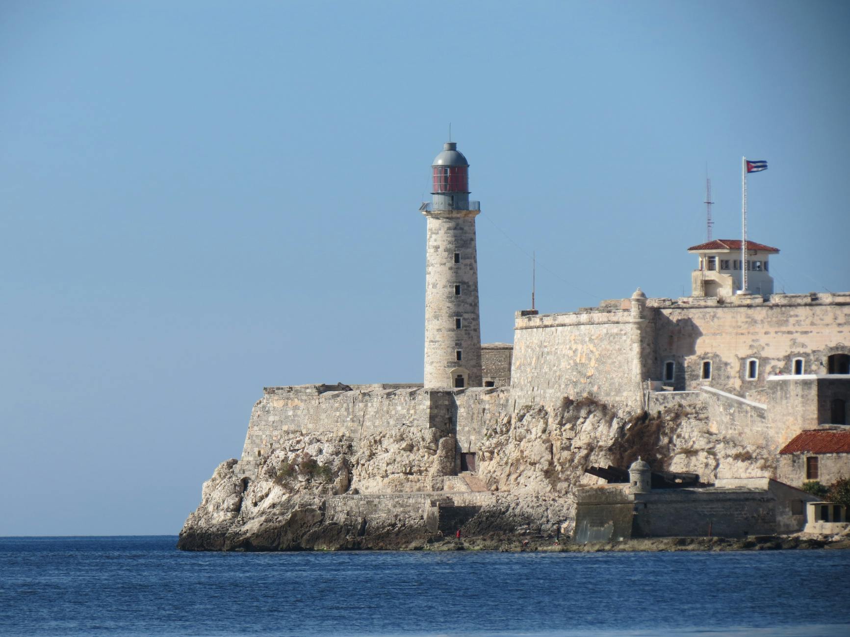 Trump Requires satire image: Majestic view of El Morro Lighthouse against the clear blue sky in La Habana, Cuba.