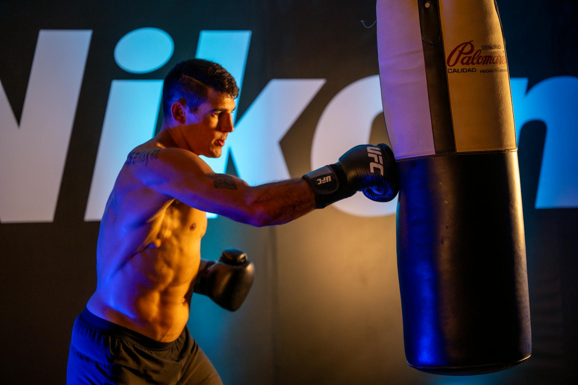 White House Replaces satire image: A male boxer trains intensely with a punching bag indoors at a gym in Mexico City.