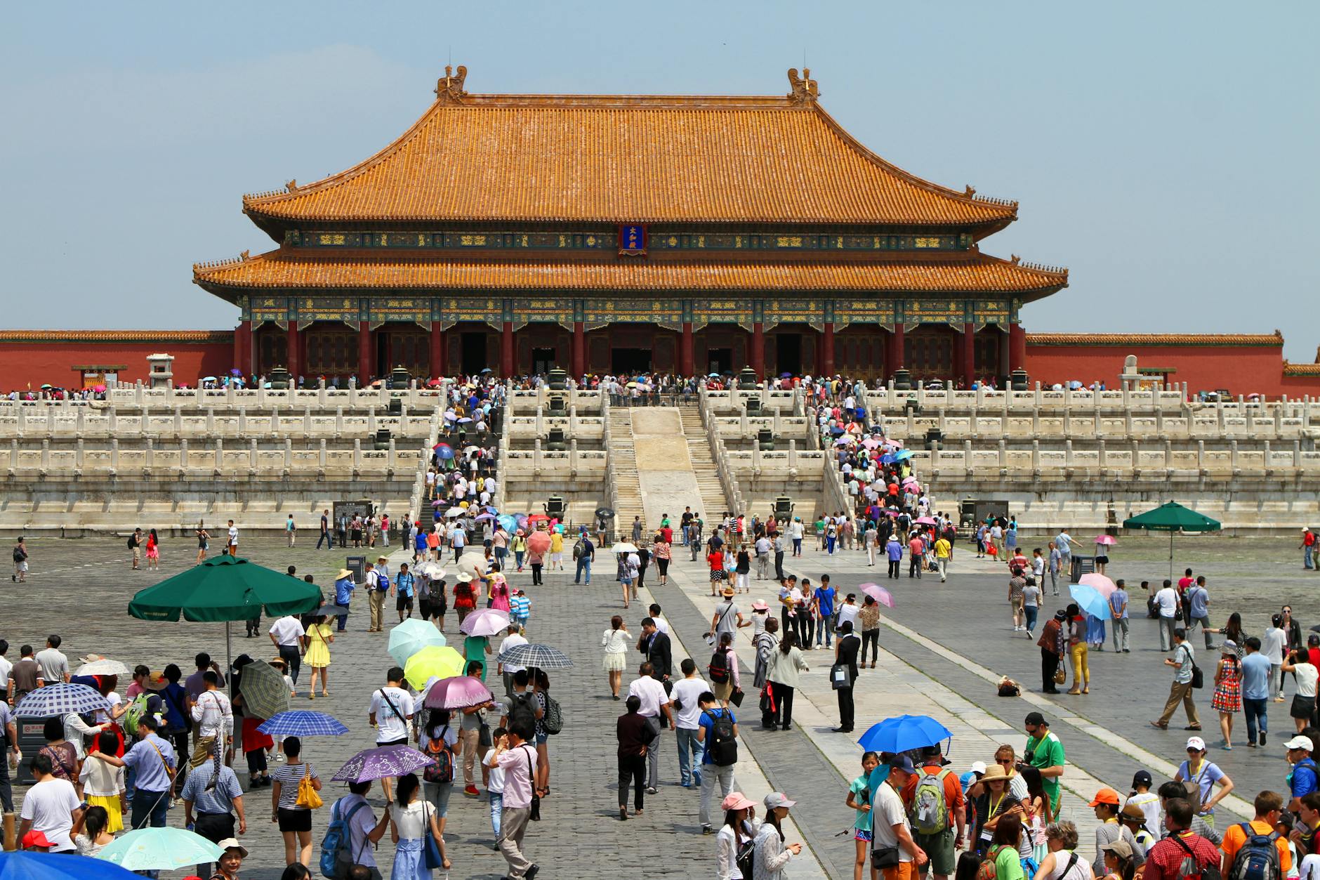 Crowds visiting the historic Forbidden City in Beijing, China on a sunny day.