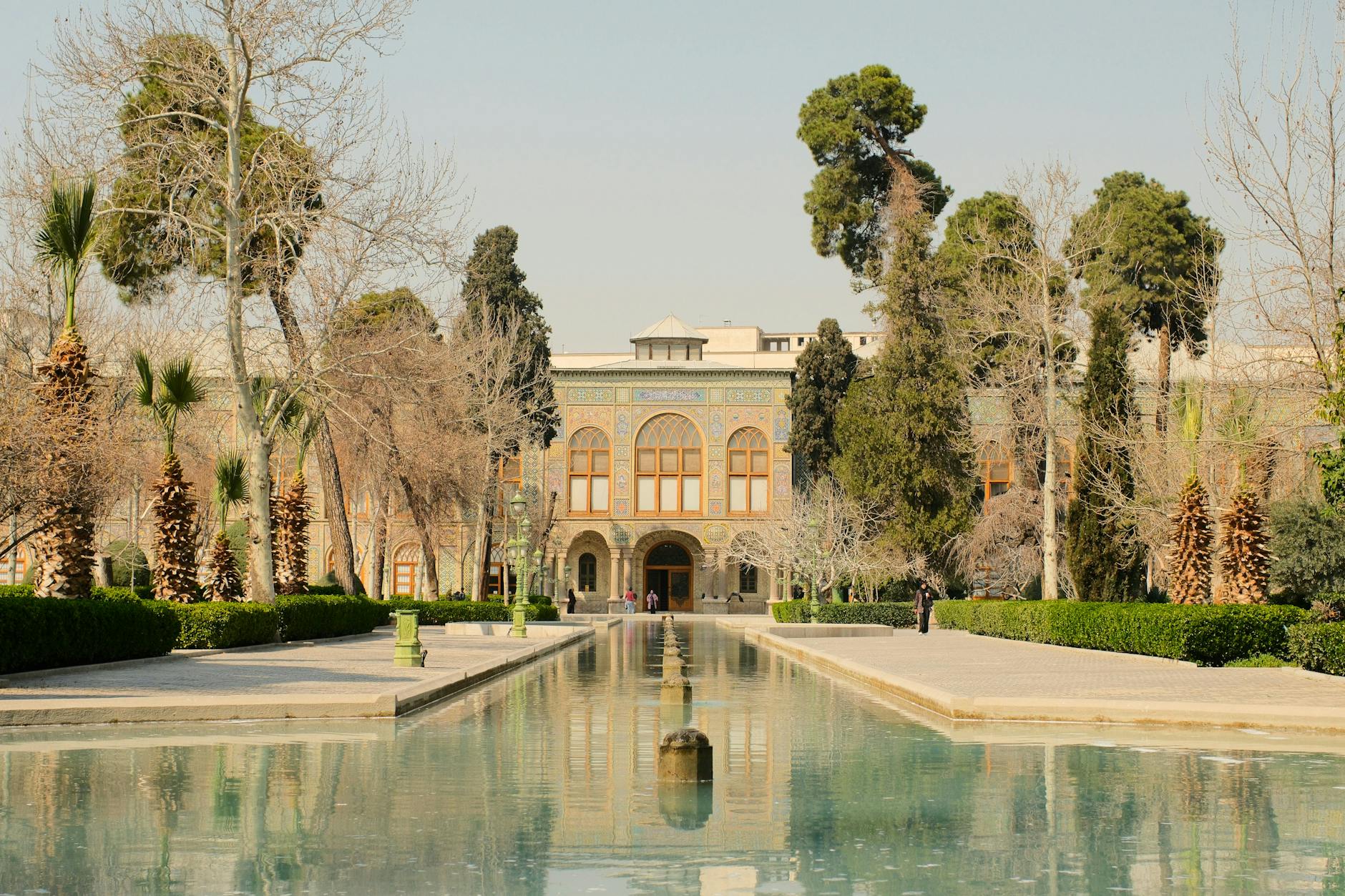 Explore Tehran's iconic Golestan Palace featuring a stunning reflection pool and Persian architecture.