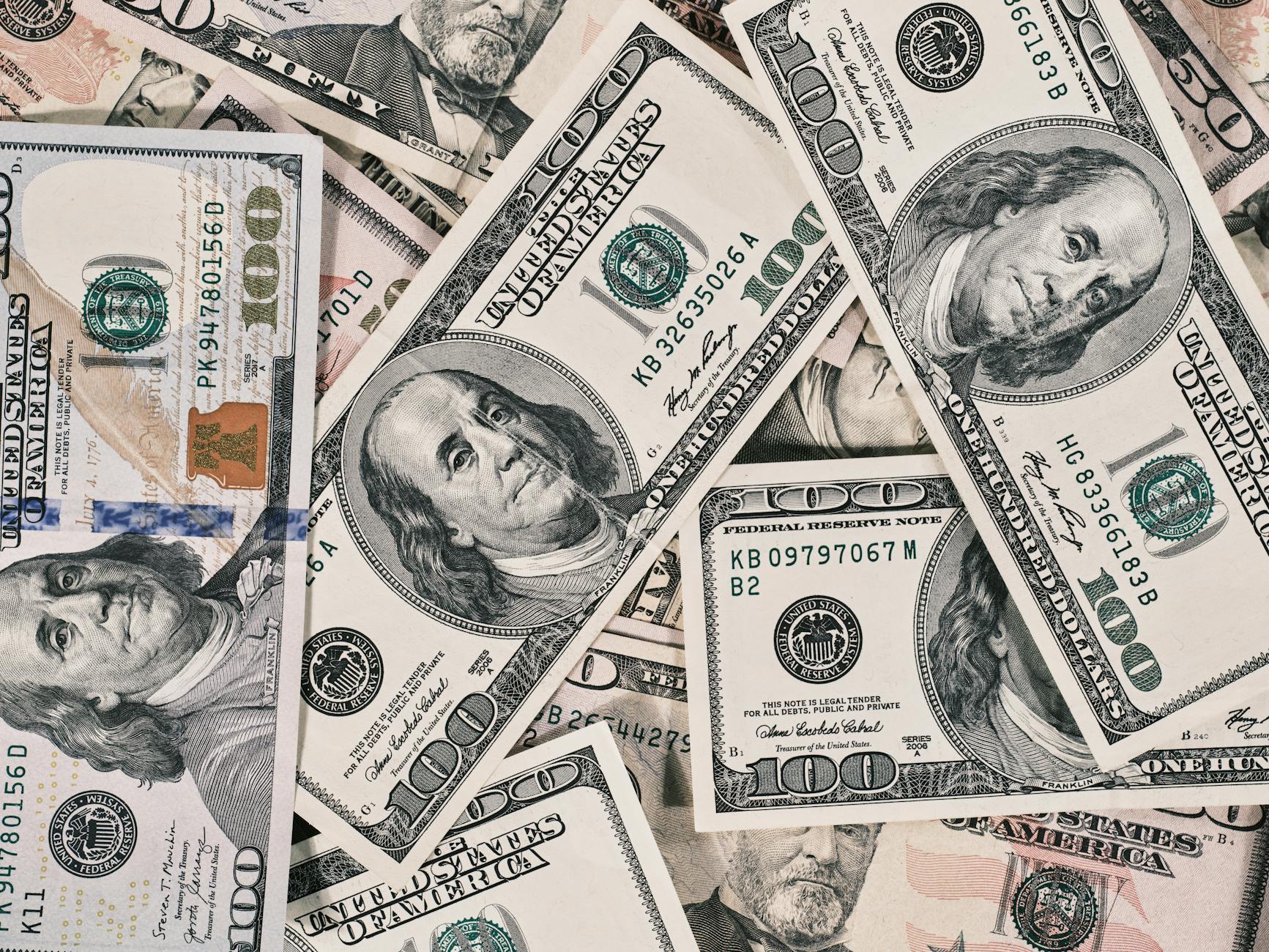 Trump Measures satire image: Detailed close-up of US dollar bills highlighting wealth and finance concepts.