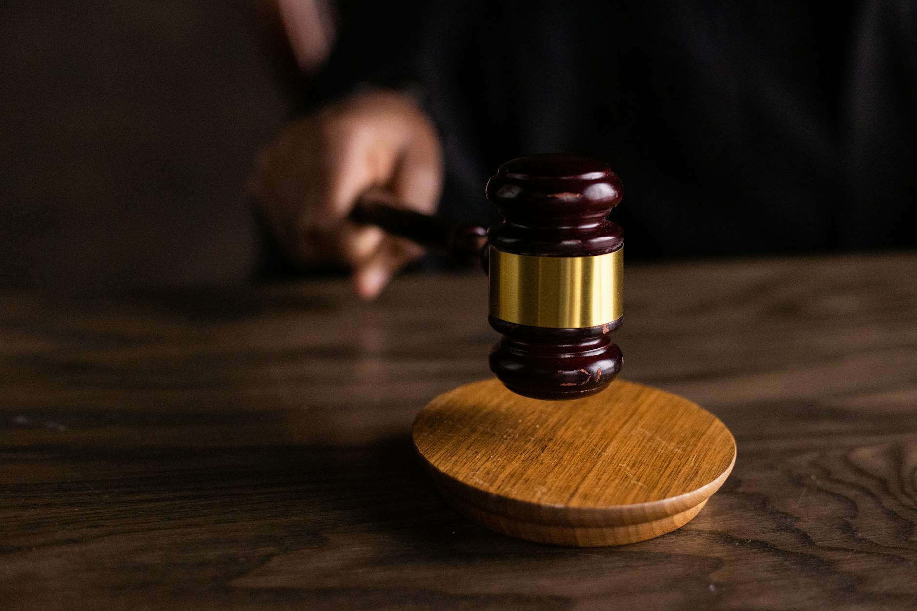 Supreme Court Declines satire image: A gavel striking a sound block, symbolizing justice and legal authority in a courtroom setting.