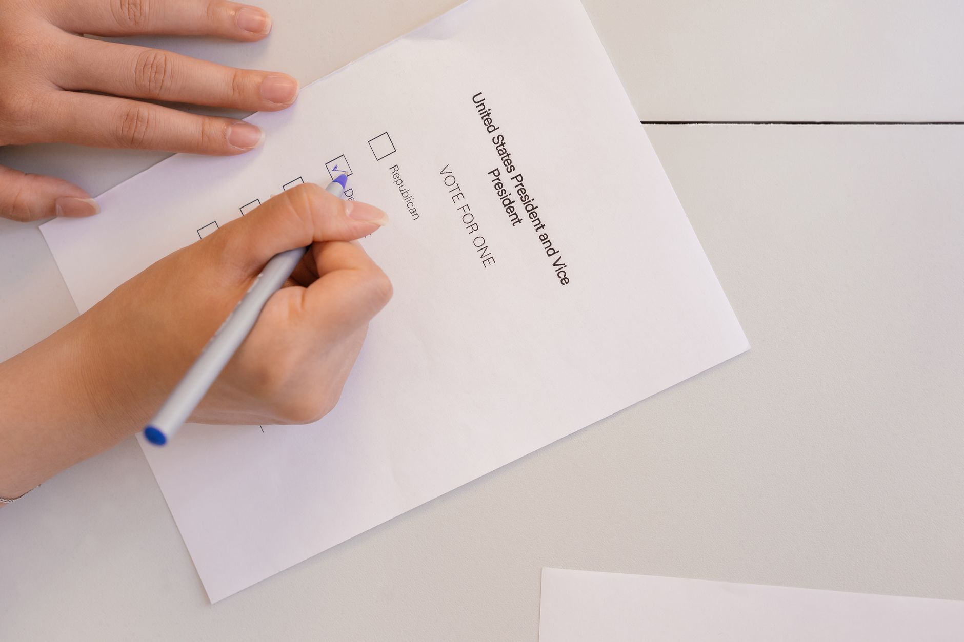 Congress Montana satire image: Hand placing vote on ballot form during election process, highlighting civic duty and democracy.