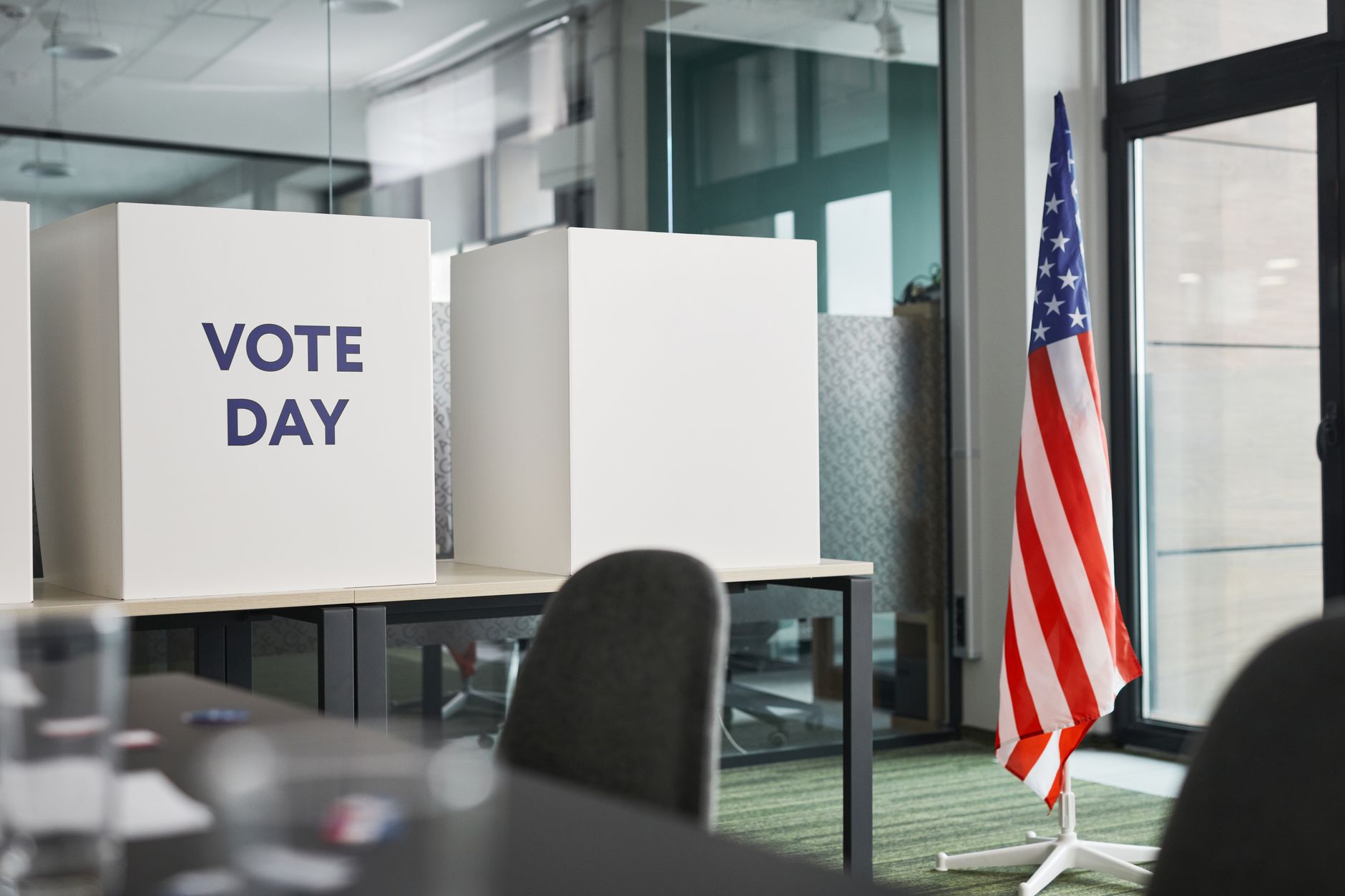 satire-image-29 Congress Illinois satire image: Voting booths with an American flag in an office, symbolizing Election Day.