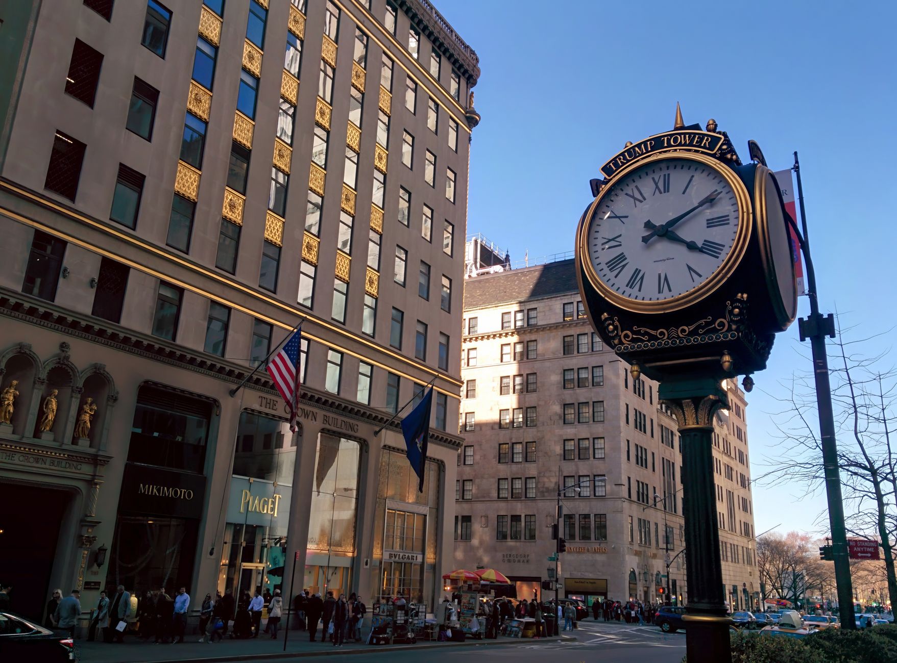 satire-image-35 Trump Nyc satire image: Street view of New York City featuring a classic clock tower against urban architecture.