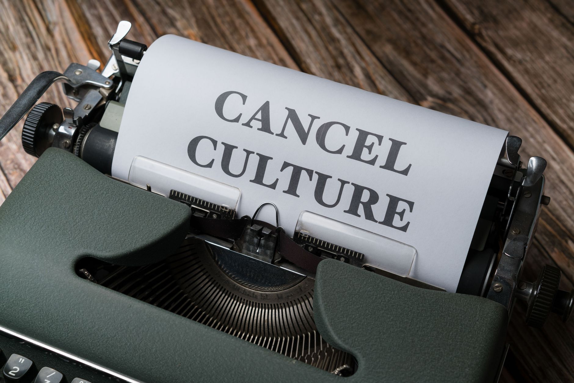 satire-image-47 Supreme Court Orders satire image: Vintage typewriter with paper reading 'Cancel Culture' on wooden surface.