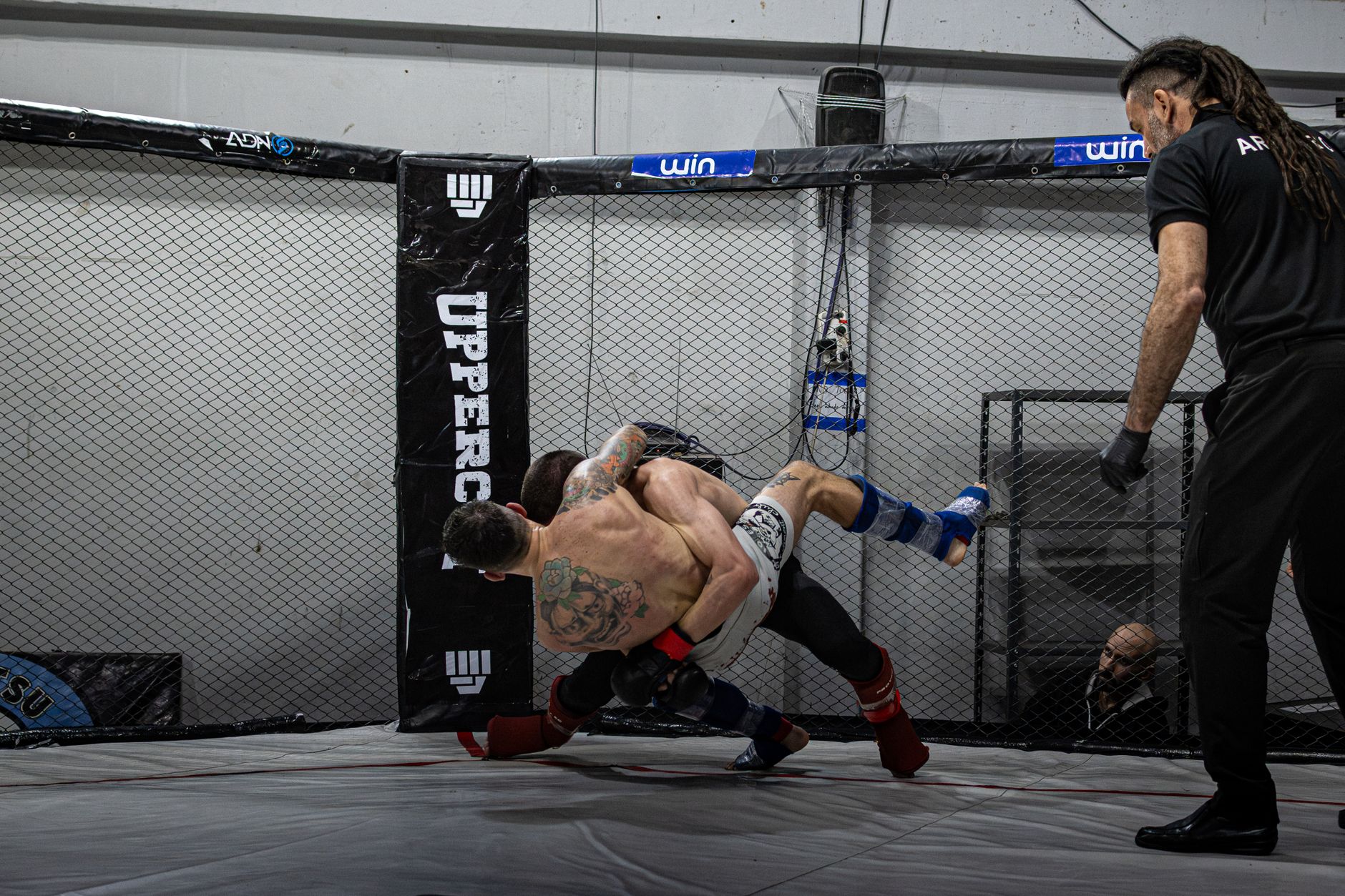 satire-image-56 Trump Releases satire image: Two MMA fighters battling in a cage during a match in Buenos Aires.