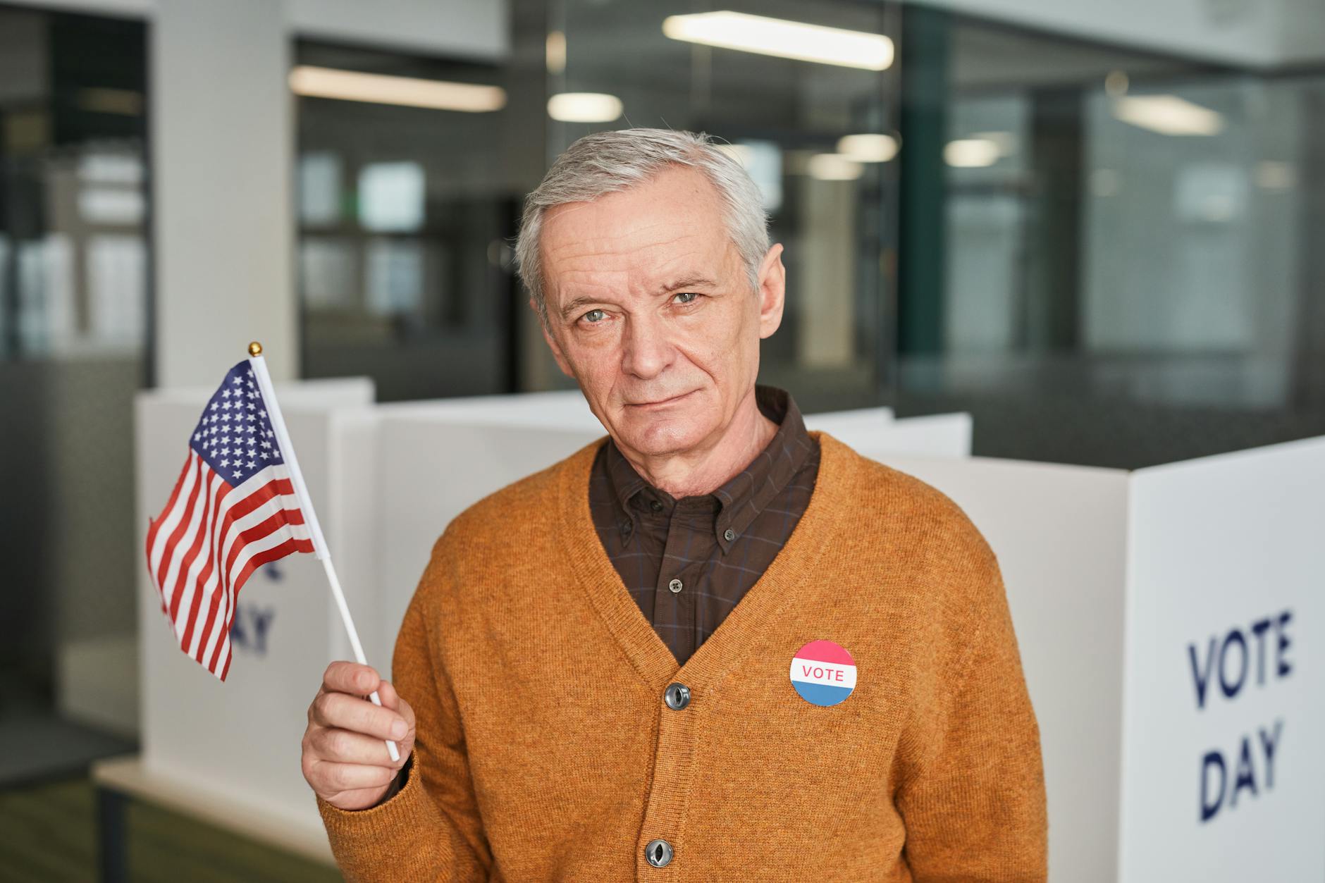Congress Nebraska satire image: Elderly man with American flag and vote sticker in polling station. Emphasizing civic duty and