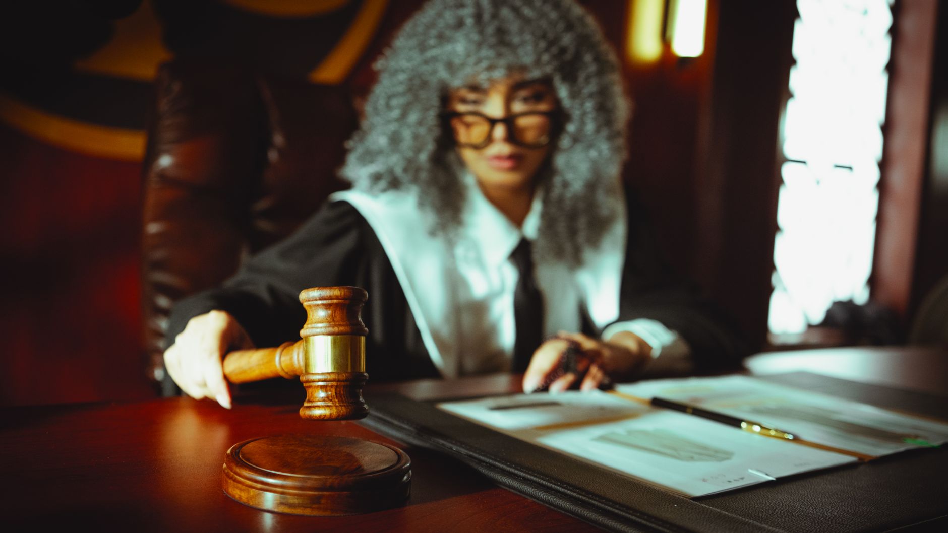 satire-image-67 Supreme Court Replaces satire image: A judge in a courtroom holding a gavel, focused on legal documents.