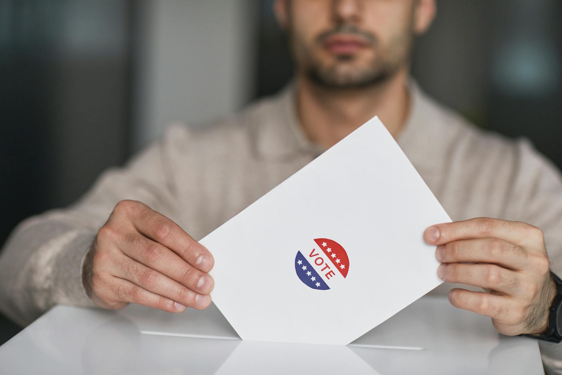 Congress Iowa satire image: A man holds a voting envelope with a vote sticker. Symbolizes election participation.