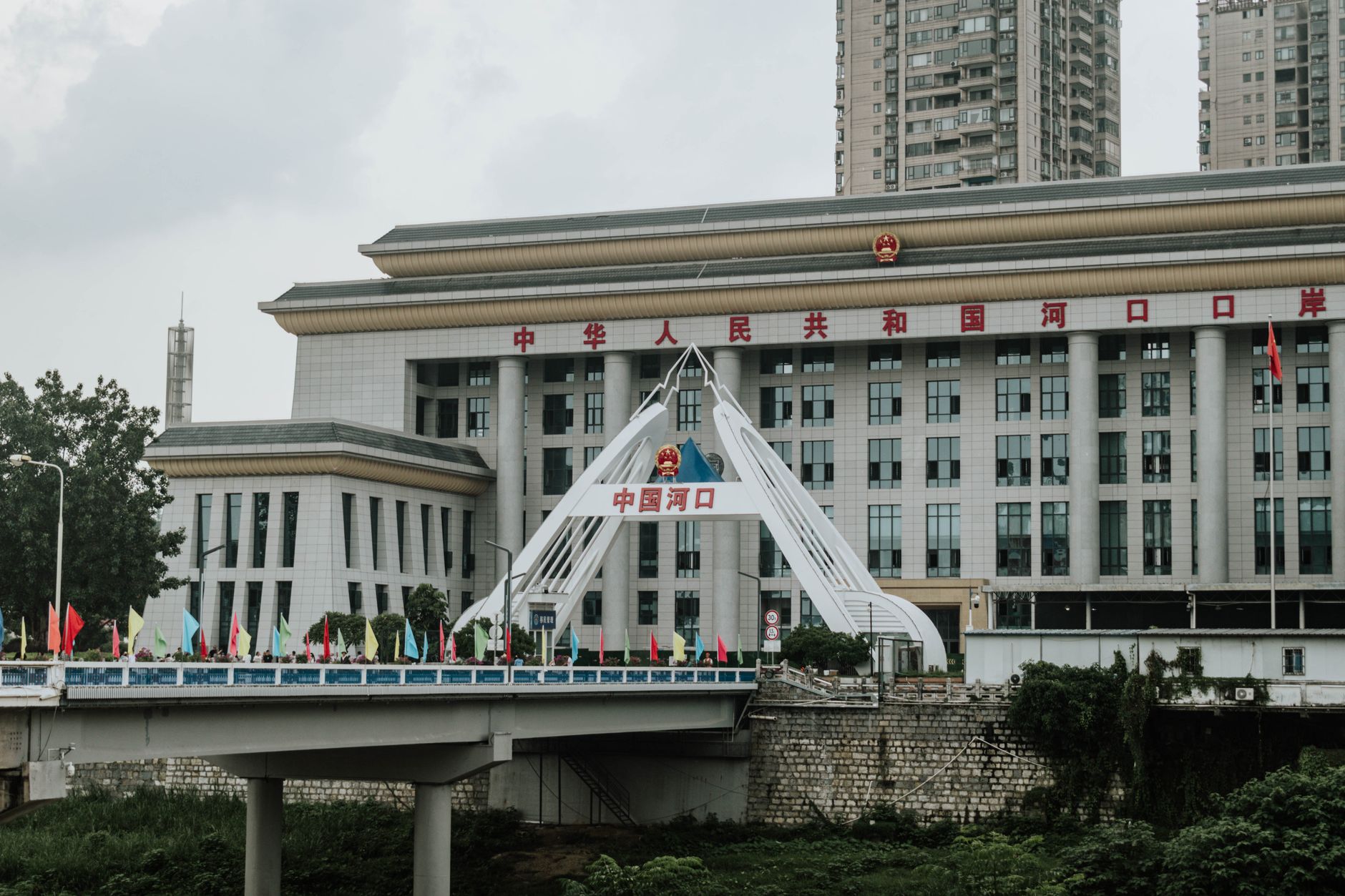 Trump Builds satire image: Urban scene featuring a bridge and government building in China.