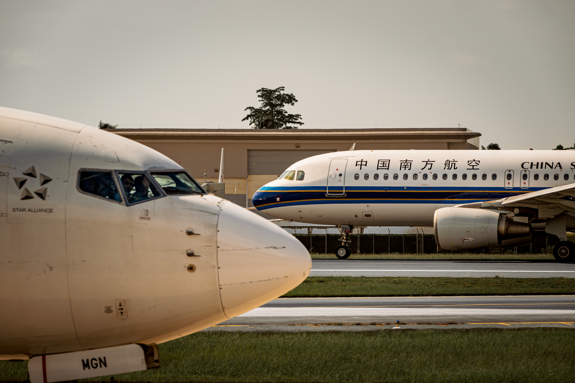 satire-image China Washington satire image: Two commercial airplanes on the runway at sunset, ready for departure.